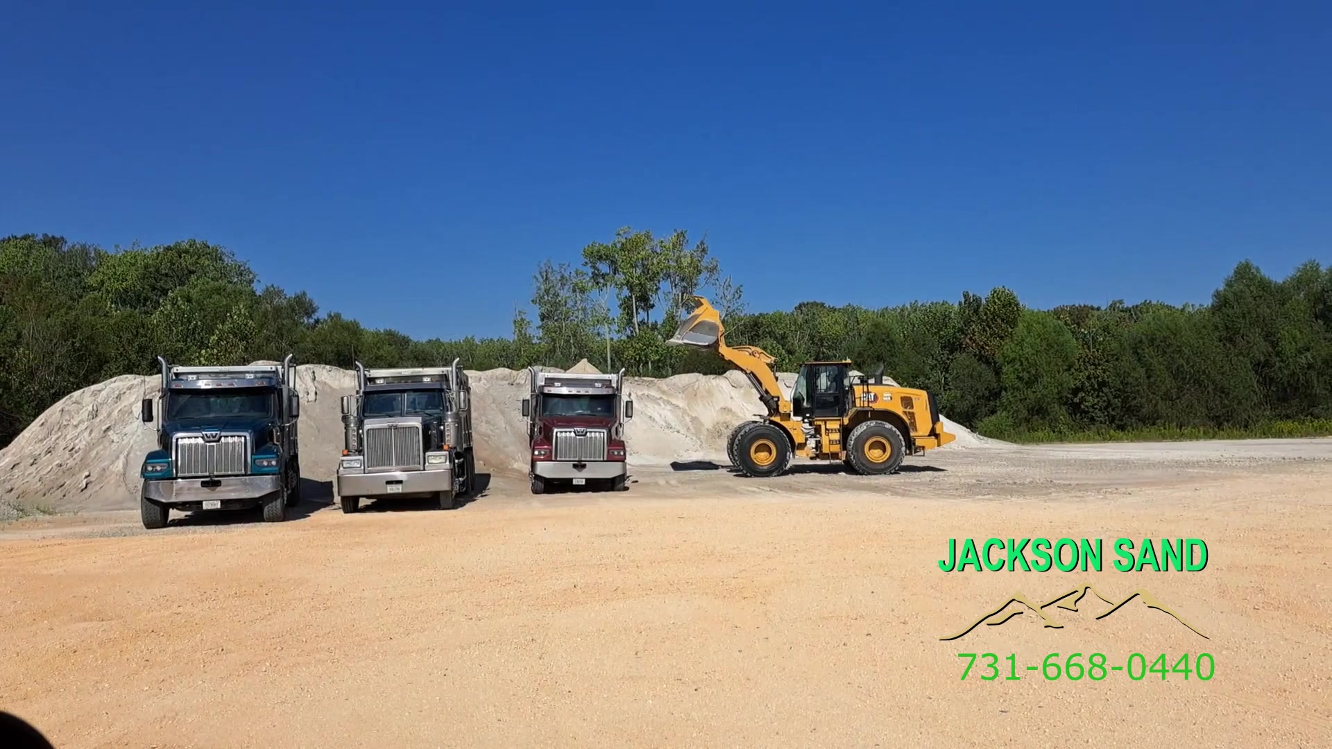 Jackson Sand truck fleet and loader at the sand yard in Jackson, Tennessee